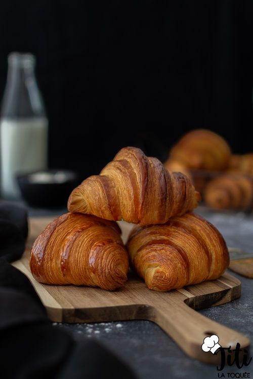 Fresh croissants on a wooden board