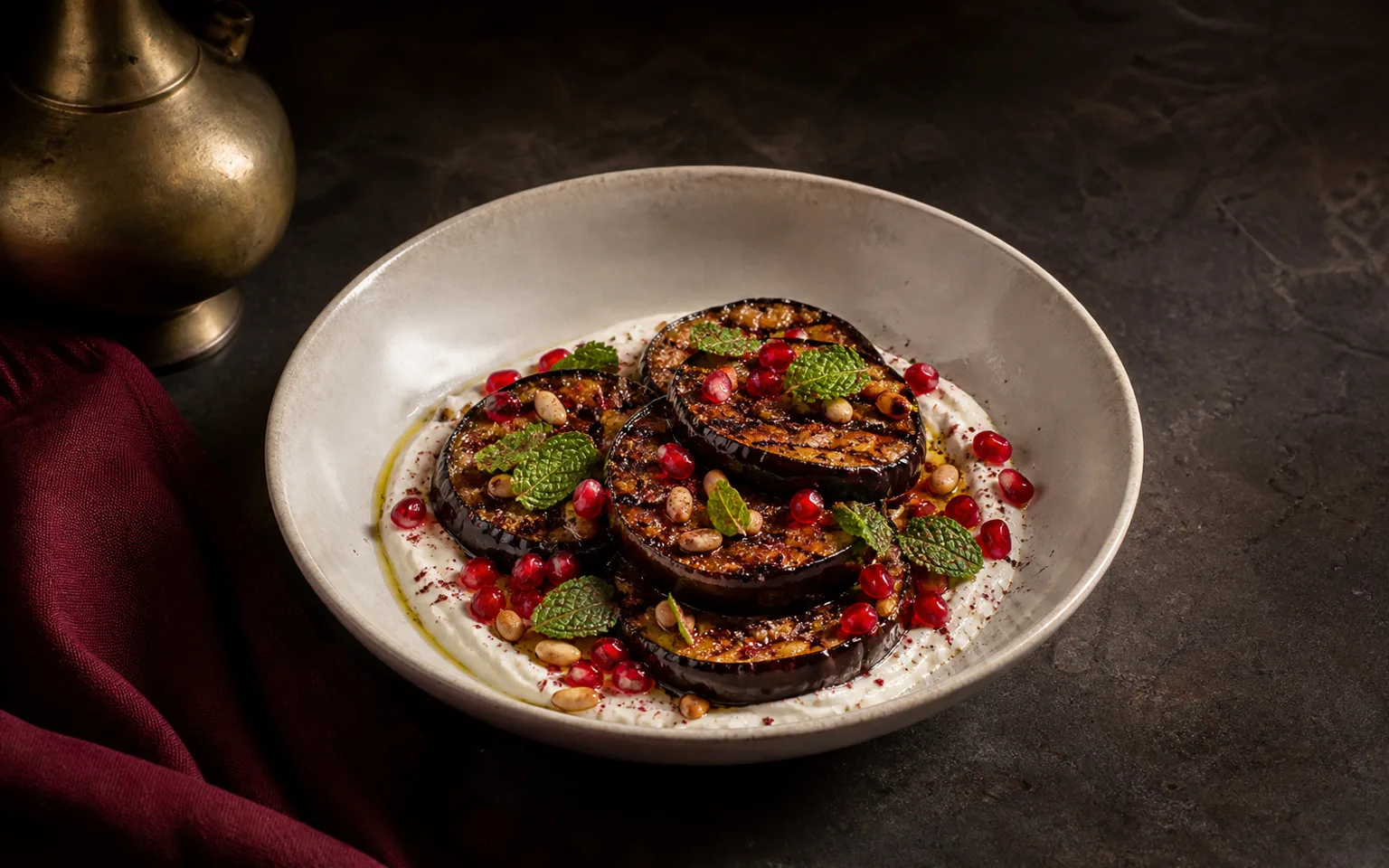 Charred aubergine with labneh, pomegranate, pine nuts, and mint
